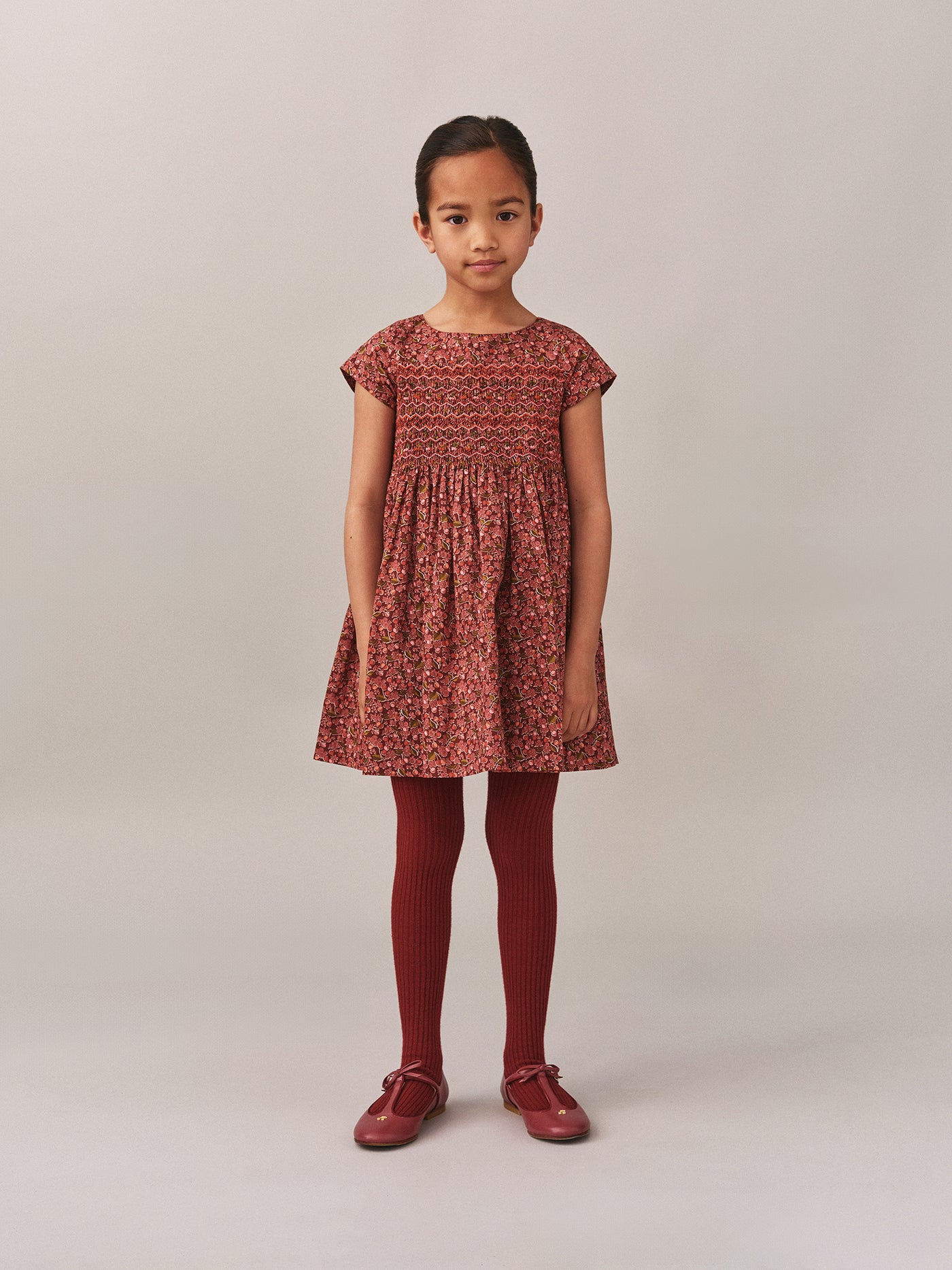 Smocked and embroidered Duchesse dress in Liberty fabric in organic cotton