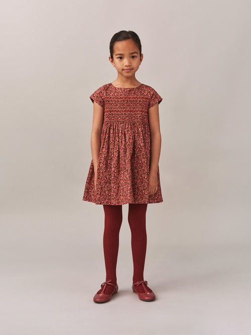 Smocked and embroidered Duchesse dress in Liberty fabric in organic cotton