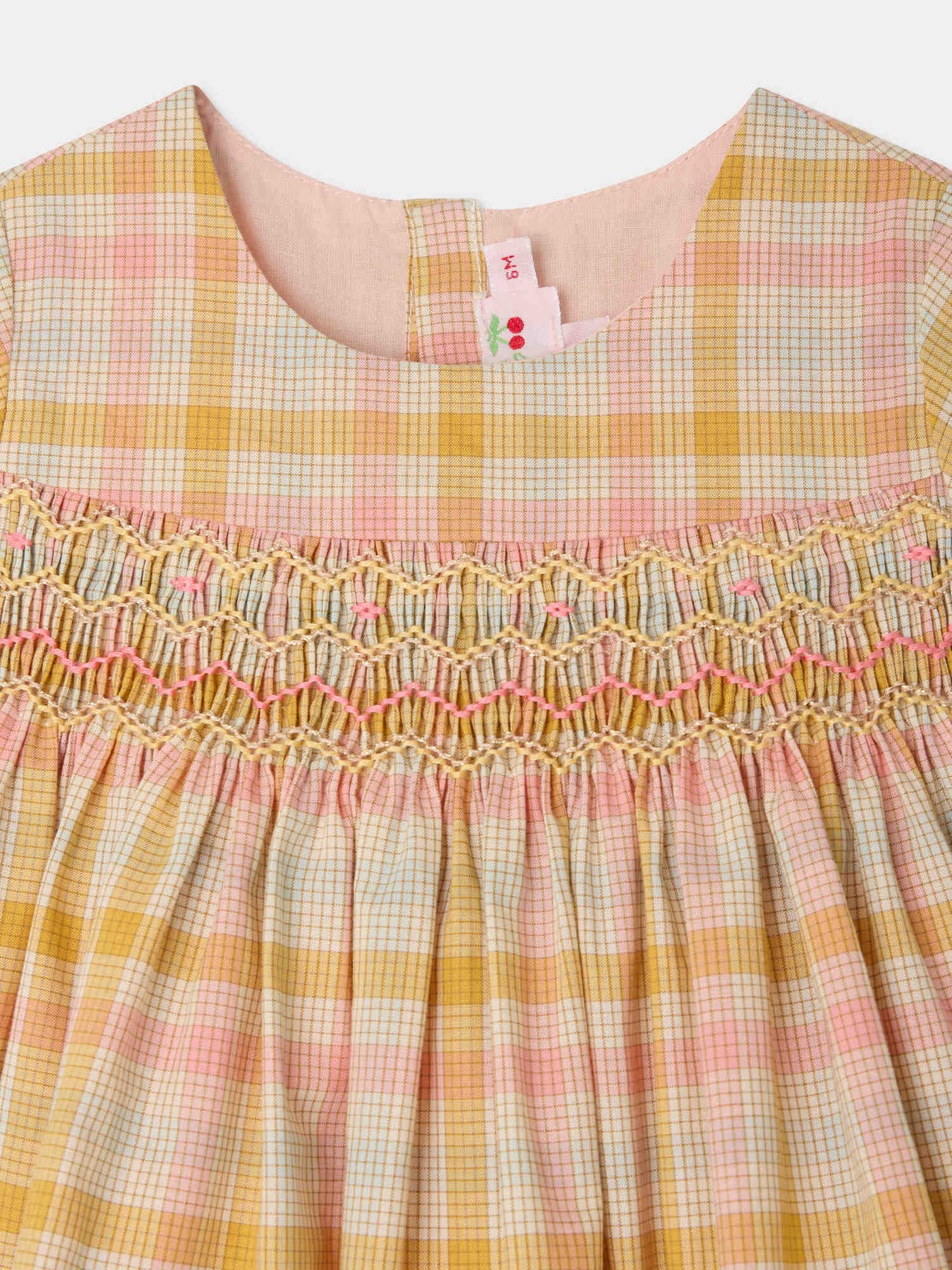 Marushka smocked and hand-embroidered dress in organic cotton