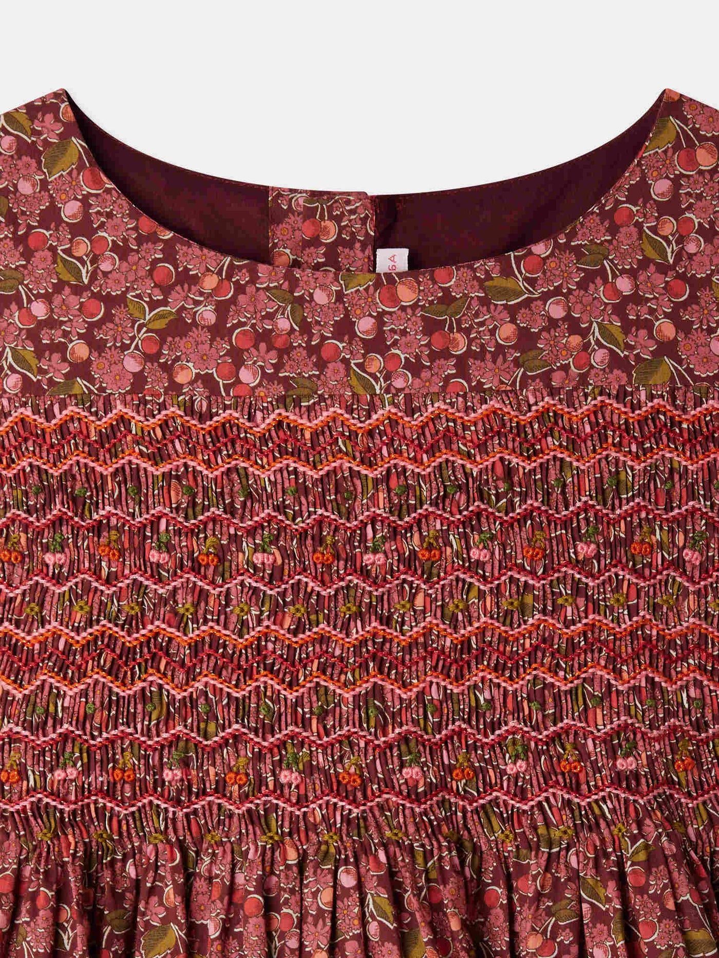 Smocked and embroidered Duchesse dress in Liberty fabric in organic cotton